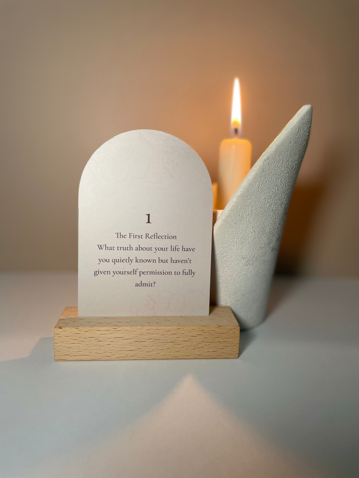 The First Reflection card lit by candlelight